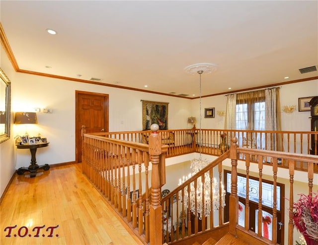 corridor with crown molding and hardwood / wood-style flooring