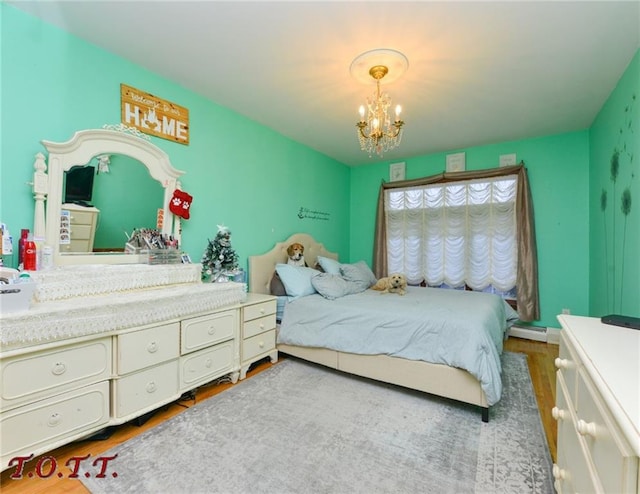 bedroom with an inviting chandelier, hardwood / wood-style floors, and baseboard heating