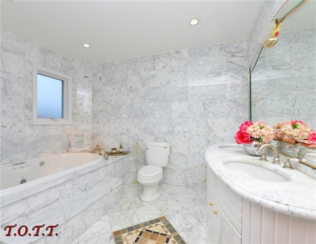 bathroom featuring tiled tub, vanity, tile walls, and toilet