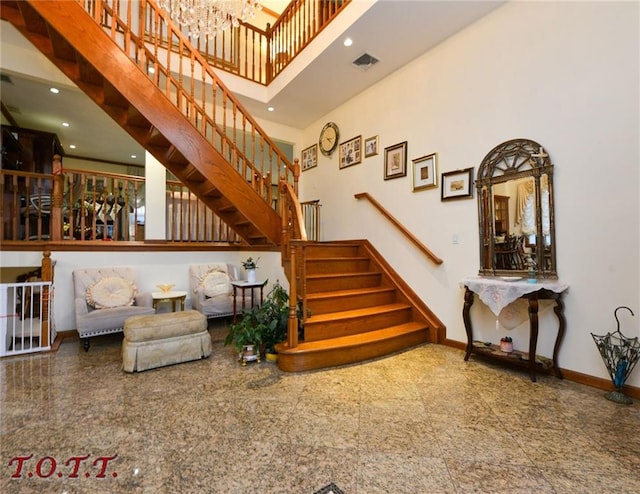 interior space with visible vents, baseboards, a towering ceiling, granite finish floor, and recessed lighting