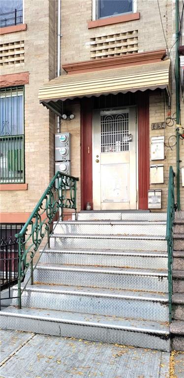 1434 65th St, Brooklyn, NY 11219 - view of exterior entry featuring brick siding and a porch