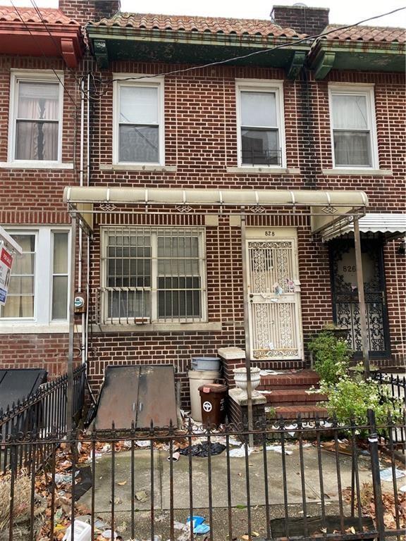 828 53rd St, Brooklyn, NY 11220 - view of front facade with brick siding and a chimney