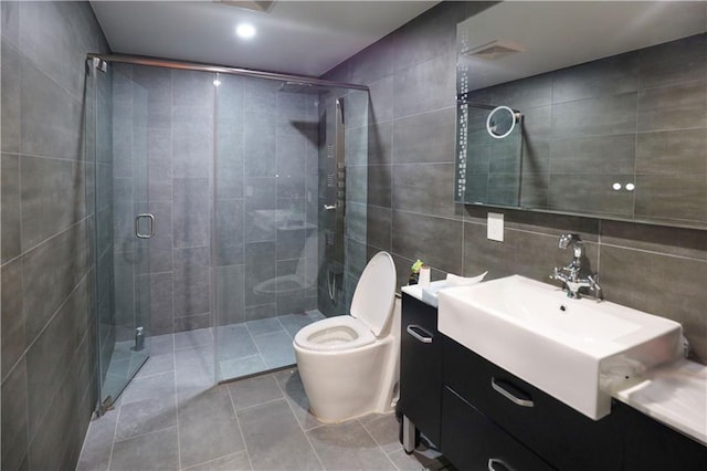 full bath featuring toilet, tile walls, a shower stall, tile patterned flooring, and vanity