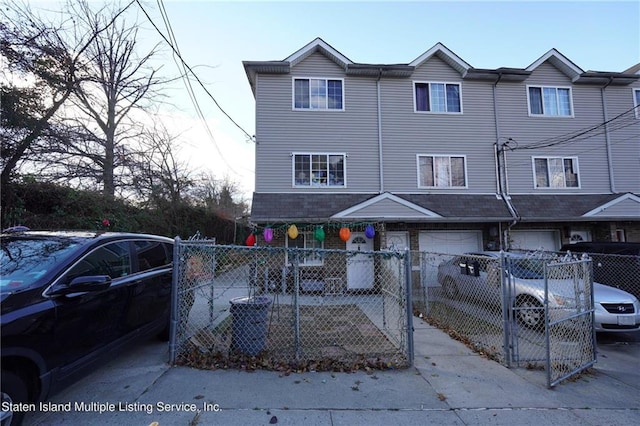 townhome / multi-family property featuring a garage