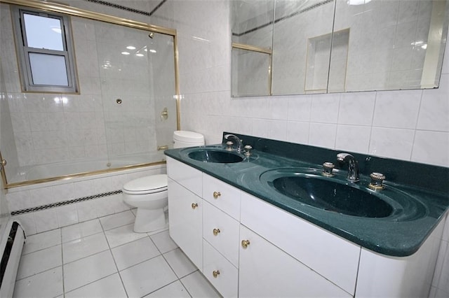 full bathroom featuring tile patterned floors, toilet, combined bath / shower with glass door, tile walls, and a baseboard radiator