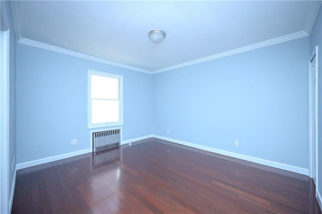 empty room featuring ornamental molding, radiator heating unit, baseboards, and dark wood-style flooring