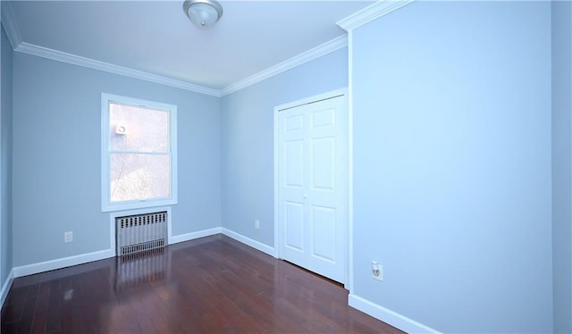 unfurnished bedroom with baseboards, radiator heating unit, a closet, ornamental molding, and dark wood-style floors