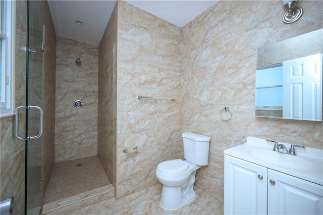 bathroom with vanity, a shower stall, and toilet