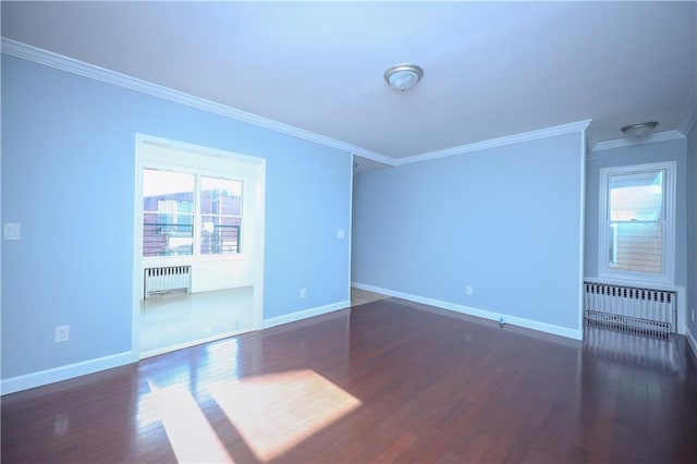 spare room with radiator, crown molding, baseboards, and dark wood-style flooring