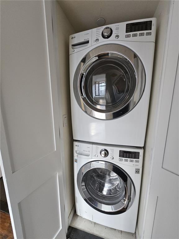 laundry room featuring stacked washer and dryer and laundry area