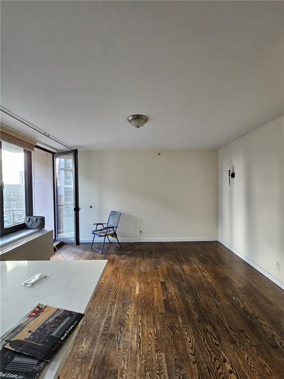 interior space featuring wood finished floors and baseboards