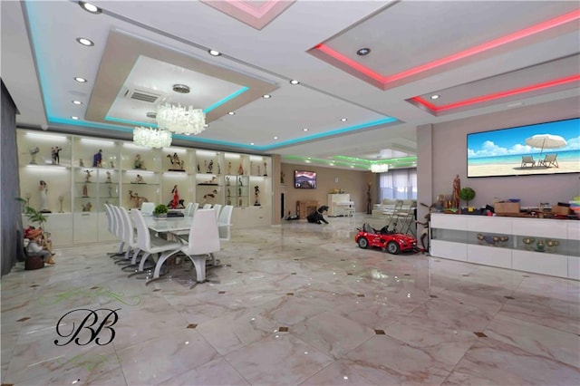 dining area featuring a chandelier and a tray ceiling