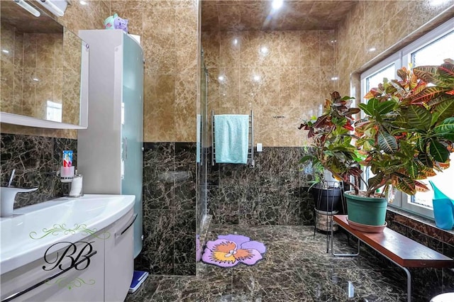 bathroom with vanity and tile walls