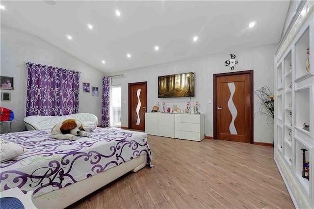 bedroom with light hardwood / wood-style floors and lofted ceiling