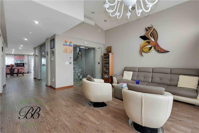 living room featuring a chandelier, wood-type flooring, and vaulted ceiling