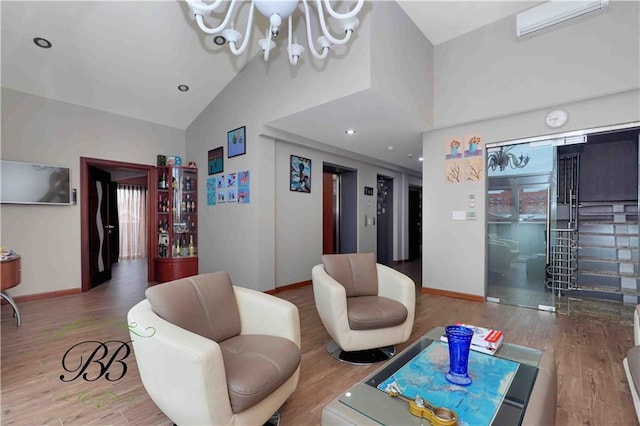 living room featuring wood-type flooring, an inviting chandelier, and high vaulted ceiling