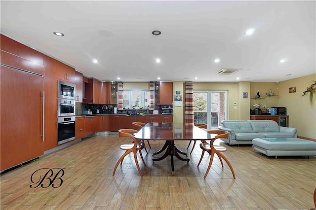 dining space featuring light wood-type flooring