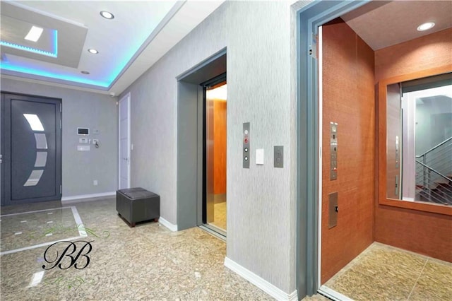 foyer featuring a raised ceiling