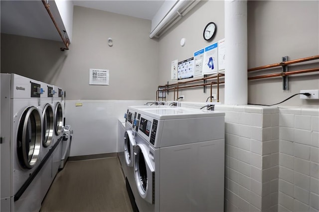 common laundry area with wood finished floors and washing machine and dryer