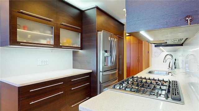 kitchen with decorative backsplash, exhaust hood, sink, and appliances with stainless steel finishes