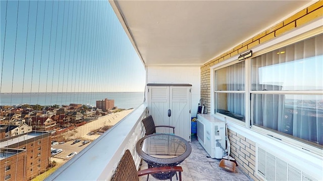 balcony with ac unit and a water view