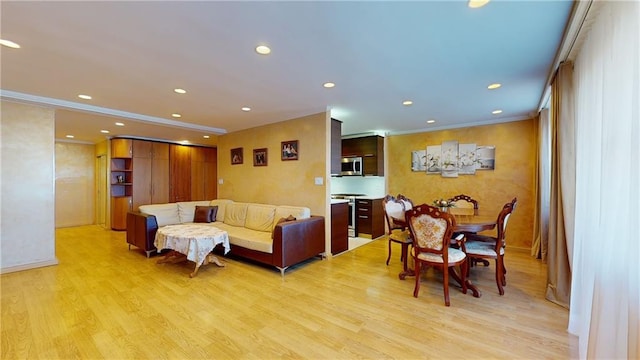 living room featuring light wood-type flooring and crown molding