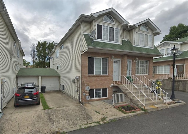 multi unit property featuring a garage and an outdoor structure