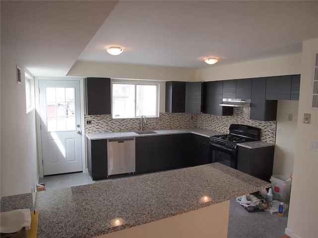 kitchen with gas stove, sink, light stone counters, stainless steel dishwasher, and backsplash