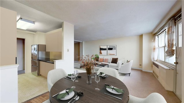 dining space featuring light colored carpet and radiator heating unit