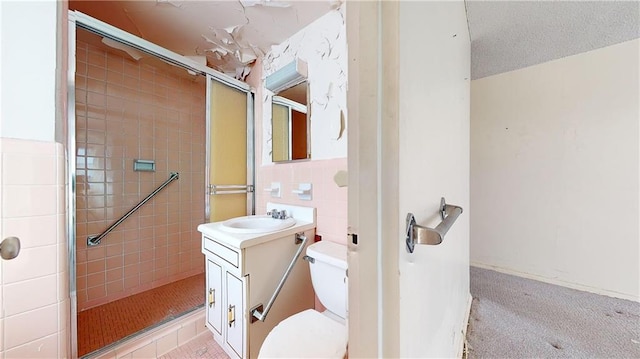 bathroom featuring vanity, toilet, a textured ceiling, and walk in shower