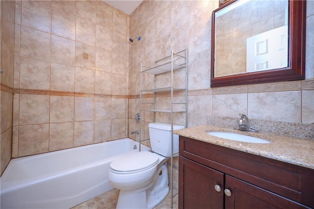 full bathroom featuring tasteful backsplash, vanity, tile walls, toilet, and tiled shower / bath