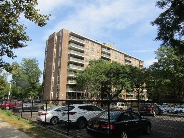 12399 Flatlands Ave Unit 1J, Brooklyn, NY 11207 - view of apartment building / complex featuring uncovered parking