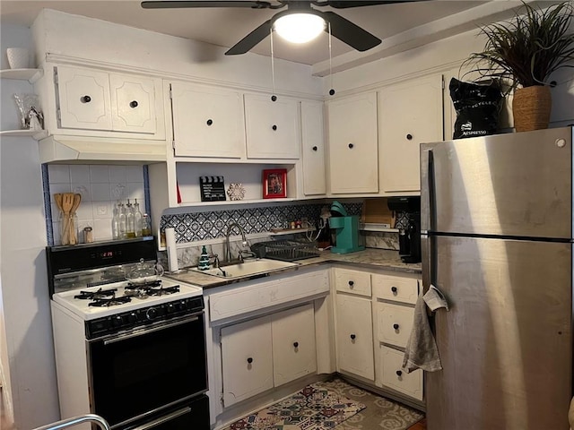 kitchen with decorative backsplash, gas stove, stainless steel fridge, and sink