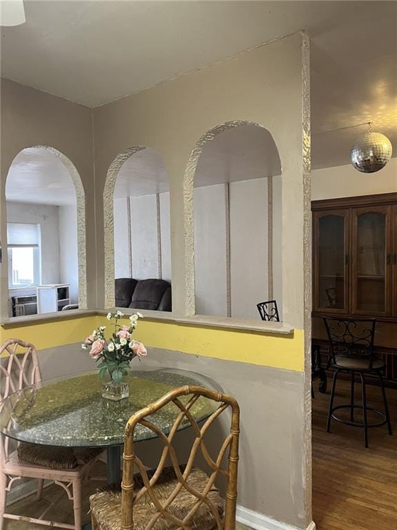 dining space with hardwood / wood-style floors