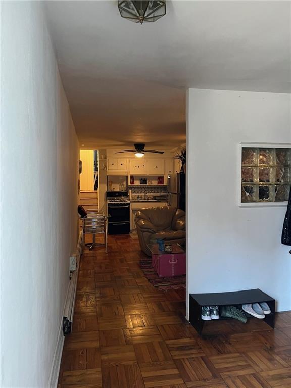 hallway with dark parquet floors