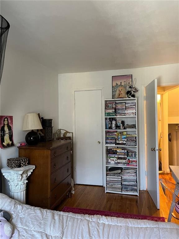 bedroom with dark wood-type flooring