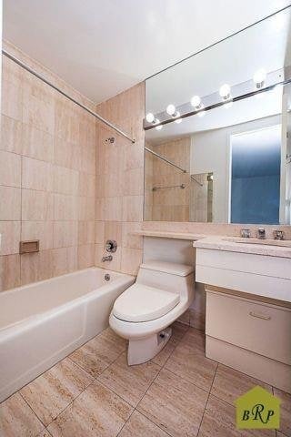 full bathroom with tile patterned flooring, vanity, toilet, and tiled shower / bath