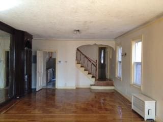 interior space featuring crown molding and dark hardwood / wood-style floors