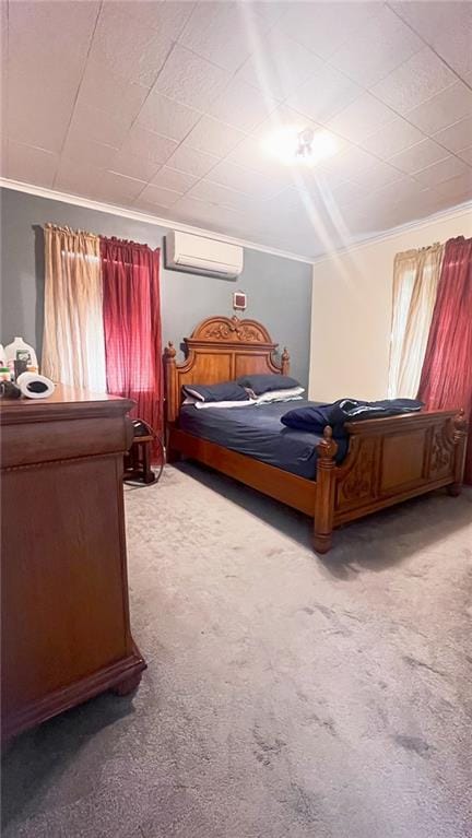 bedroom with ornamental molding, an AC wall unit, and carpet flooring