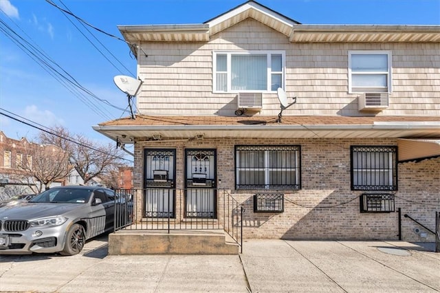 view of front of home with a porch and cooling unit