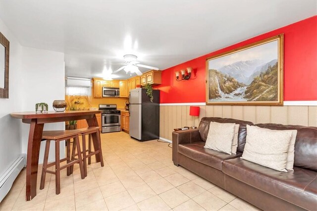 living room featuring ceiling fan and baseboard heating