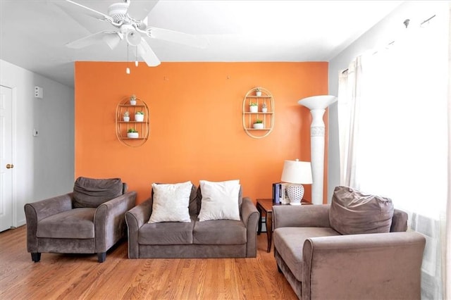 living room with ceiling fan and light wood-type flooring