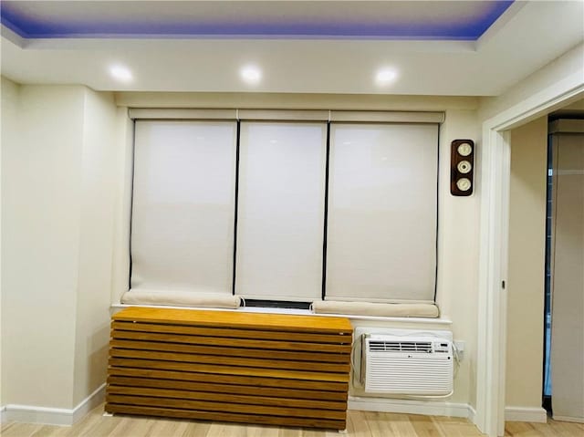 interior details featuring recessed lighting, baseboards, wood finished floors, and a wall mounted AC