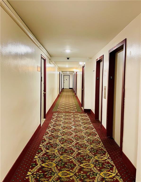 corridor with dark colored carpet