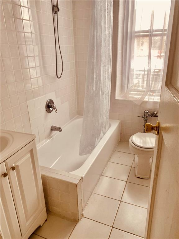 full bathroom featuring tile patterned flooring, vanity, toilet, and shower / bath combo