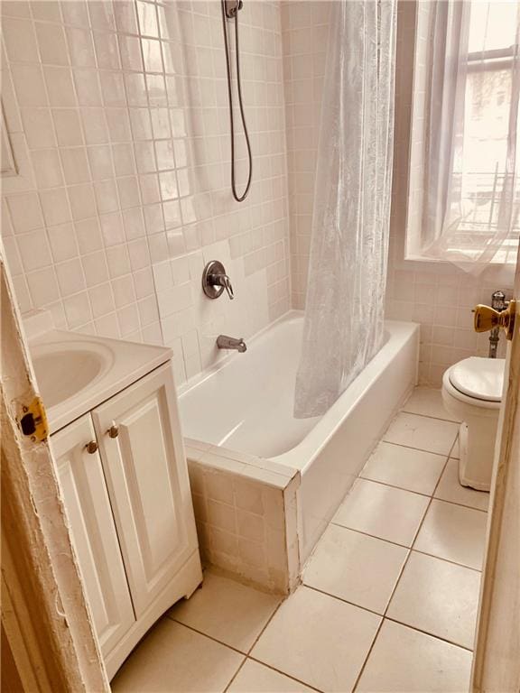 full bathroom featuring shower / tub combo with curtain, tile patterned flooring, tile walls, vanity, and toilet