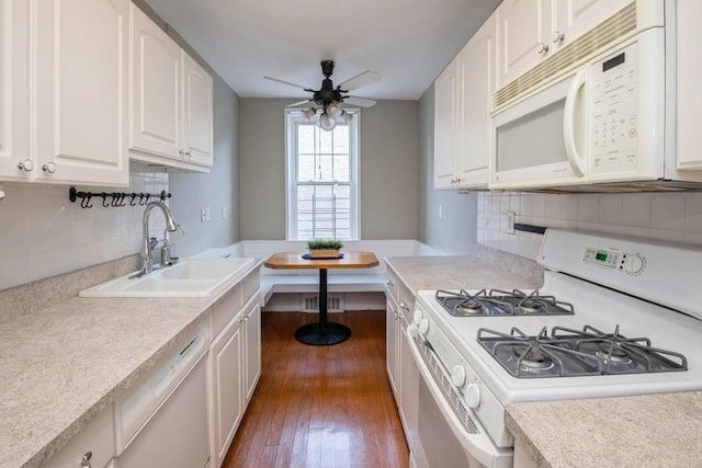 kitchen with sink, white cabinetry, dark hardwood / wood-style flooring, white appliances, and decorative backsplash