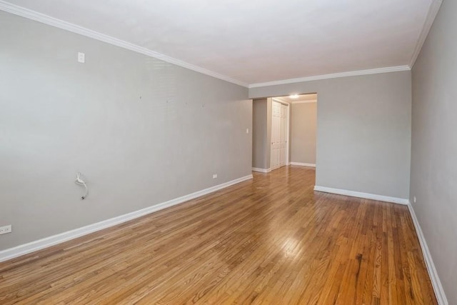 empty room with ornamental molding and light hardwood / wood-style flooring