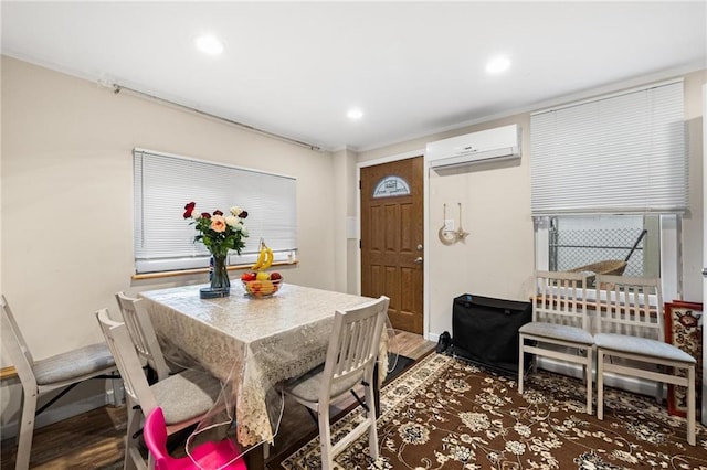 dining space featuring dark wood-type flooring and a wall mounted air conditioner