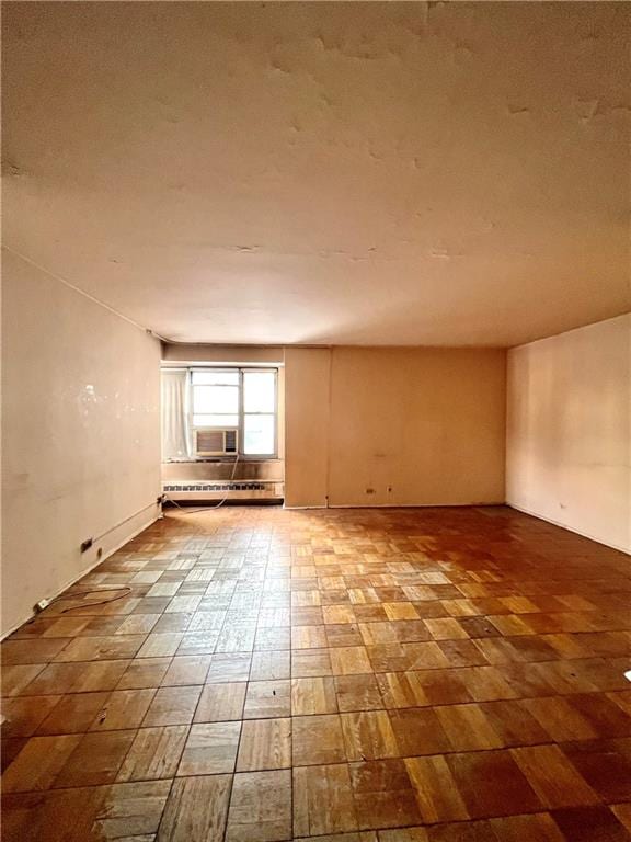 empty room featuring a baseboard heating unit